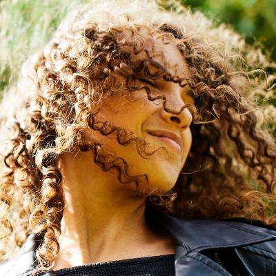 Girl swooshes hair in park